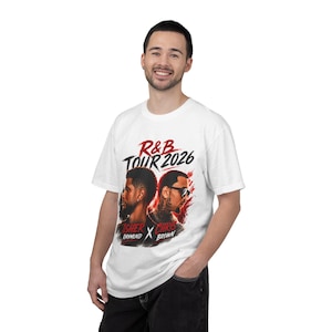May include: A white short-sleeve t-shirt featuring a graphic print with the text R&B TOUR 2026, USHER RAYMOND, and CHRIS BROWN. The design includes portraits of two individuals back-to-back with red and black paint splatter accents.