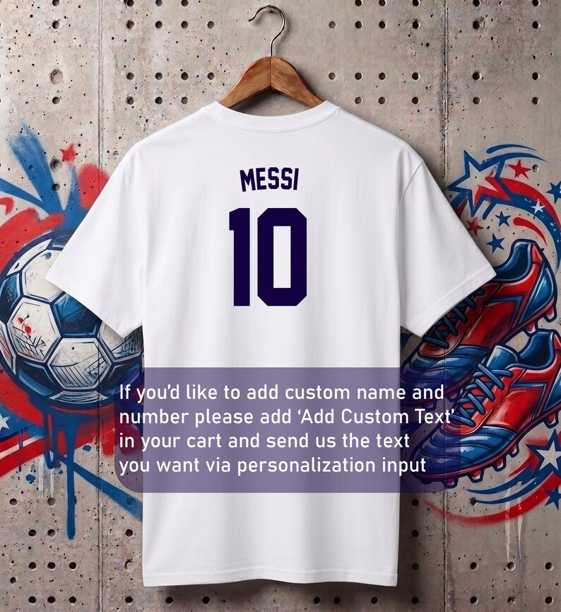 May include: White t-shirt with the name "MESSI" and the number "10" in navy blue. The shirt is hanging on a wooden hanger. Text on the image says, "If you'd like to add custom name and number please add 'Add Custom Text' in your cart and send us the text you want via personalization input."