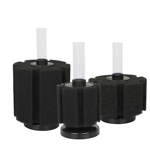 May include: Three black cylindrical aquarium sponge filters of varying heights. Each filter features a porous black foam cylinder attached to a solid black circular base, with a clear plastic tube extending vertically from the centre top.