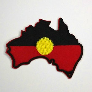 May include: An embroidered patch in the shape of Australia with the Aboriginal flag design. The flag features a black background with a red horizontal stripe and a yellow circle in the centre.