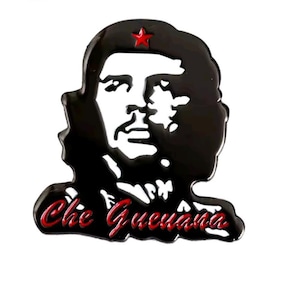 May include: A black and white enamel pin depicting Che Guevara with a red star. The pin has the words "Che Guevara" in red script. This pin is a collectible item, suitable for jackets, bags, or other accessories.