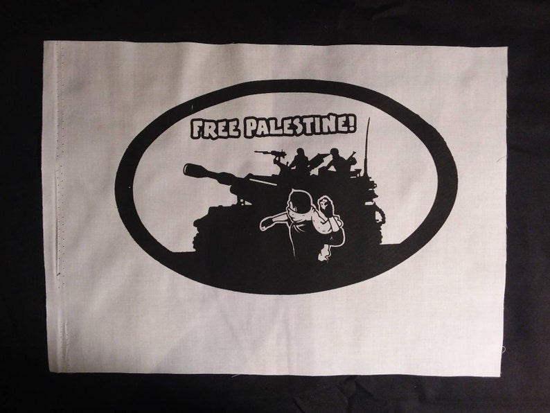 May include: A black and white image of a tank with soldiers on top, a person running away from the tank, and the text "FREE PALESTINE!" in a circle around the image.
