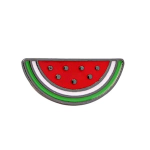 May include: A watermelon slice enamel pin. The pin features a red interior with black seeds, a white and green rind, and a dark grey border. This fruit-themed pin is a fun accessory for clothing or bags.