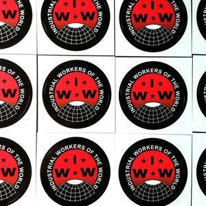May include: Nine round stickers with a red background and black text. The text reads "Industrial Workers of the World" with a stylized "IWW" logo in the center. The logo features a red star between two white "W"s.