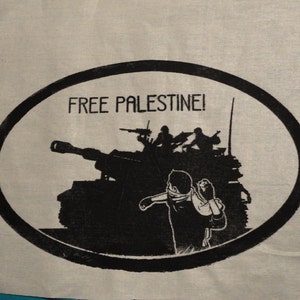 May include: A black and white image of a tank with soldiers on top. The tank is in a circle with the text "FREE PALESTINE!" above it.