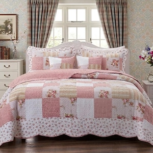May include: A patchwork quilt set featuring a repeating pattern of red and white gingham squares, solid white squares, and squares with a floral print. The quilt has a scalloped edge and includes two matching pillow shams with the same design.