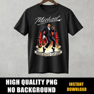 May include: Black t-shirt featuring a graphic of a man in a black suit and red jacket, with the text "Michael" above and "THE KING OF POP" below. The shirt is hanging on a wooden hanger.
