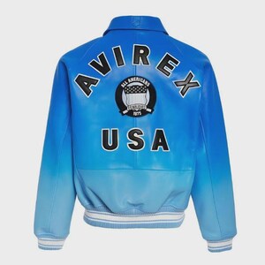 May include: Blue leather jacket with the word "AVIREX" arched across the shoulders in black lettering. Below the lettering is a circular patch with the words "All Americans Established 1975". The word "USA" is printed in white block letters below the patch. The jacket has a gradient color scheme.