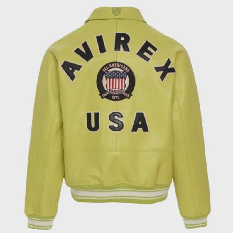 May include: A chartreuse leather jacket with the word "AVIREX" arched across the shoulders. Below is a circular patch with the words "ALL AMERICANS ESTABLISHED 1975" and a US flag design. The word "USA" is below the patch.