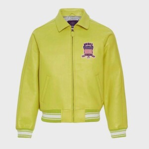 May include: A bright yellow leather jacket with a zip-up front, collar, and ribbed cuffs and hem. The jacket features a patch on the chest with a red, white, and blue design and the word "AVIREX".