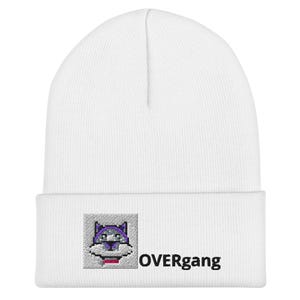 May include: White beanie with a pixelated wolf graphic in purple, gray, and red. The word "OVERgang" is printed in black below the graphic. The beanie is made of a soft, knitted material.