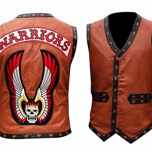 May include: A tan leather vest featuring a black diamond-patterned trim along the edges. The back displays a large patch with the text WARRIORS in red letters above a graphic of a skull with wings. The front includes four buttons and two pockets.