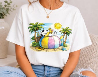 Snoopy e Woodstock si rilassano in spiaggia (Download immediato in formato PNG)