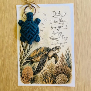 May include: A Father's Day card with a macrame turtle keychain attached. The card features a watercolor illustration of a sea turtle and reads "Dad, I turtley love you. Happy Father's Day, love Anya".
