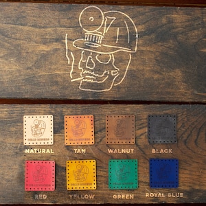 May include: A display of leather patches with a skull design and the text "Dead Miners". The patches are shown in 10 different colors: natural, tan, walnut, black, red, yellow, green, royal blue, brown, and dark brown.