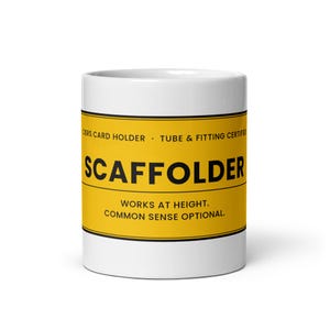 May include: A white ceramic mug featuring a yellow horizontal band with black text that reads CISRS CARD HOLDER, TUBE & FITTING CERTIFIED, SCAFFOLDER, WORKS AT HEIGHT, and COMMON SENSE OPTIONAL. The design mimics a safety sign on a cylindrical mug.