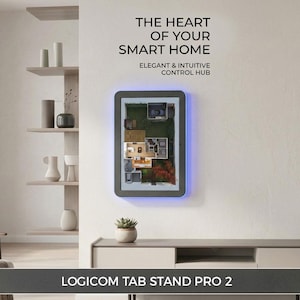 May include: A Logicom Tab Stand Pro 2 wall-mounted control hub featuring a rectangular frame with blue LED accent lighting. The screen displays a 3D floor plan. Text above reads: THE HEART OF YOUR SMART HOME ELEGANT & INTUITIVE CONTROL HUB.
