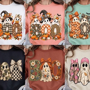 May include: A collection of six crewneck sweatshirts featuring various graphic designs of three ghosts and the word BOO. The prints include patterns like leopard print, plaid, camouflage, and floral motifs, accented with pumpkins, bows, and hats.
