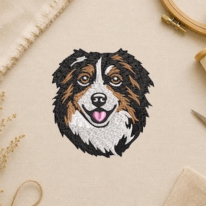 May include: Embroidered patch featuring a smiling dog's face. The dog has black, brown, and white fur, with a pink tongue. The patch is likely for sewing onto clothing or accessories, perfect for dog lovers.
