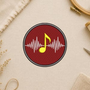 May include: Embroidered patch featuring a yellow musical note and a white sound wave design on a red background, encircled by a black and silver border. The patch is circular and likely for clothing or accessories.