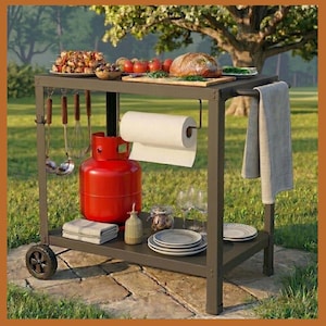 May include: A dark gray outdoor grilling cart with a red propane tank, paper towel holder, and various grilling tools. The cart has a top shelf with food items like bread, tomatoes, and grilled skewers. A gray towel hangs on the side.
