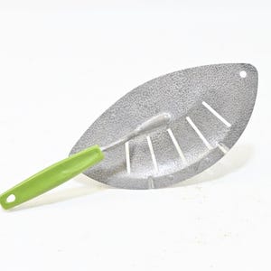 May include: A silver-colored metal kitchen strainer with a leaf-shaped design featuring five parallel drainage slots. The tool includes a bright green handle with a textured grip and a small circular hole at the end for convenient hanging storage.