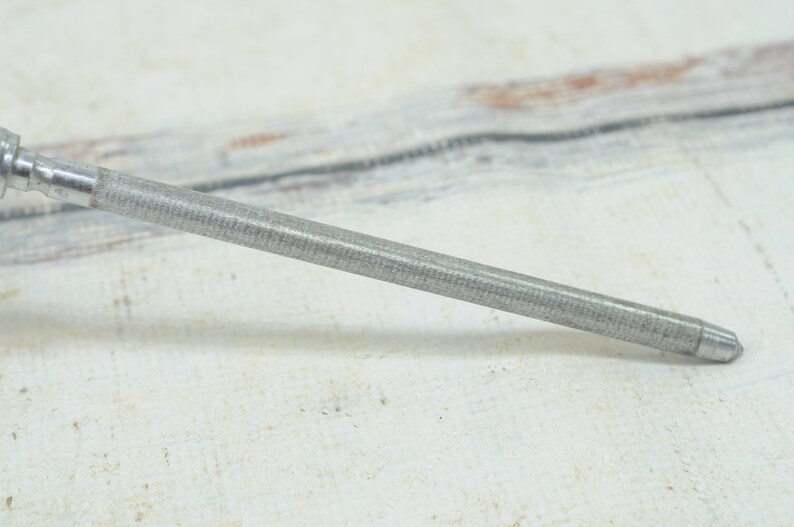 May include: A silver metal sharpening steel with a textured surface.