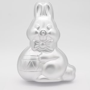 May include: A trio of ceramic mugs with a speckled, matte finish in cream, light brown, and dark brown. Each mug features a minimalist design and a rounded handle. Suitable for tea or coffee, these mugs offer a simple, rustic aesthetic.