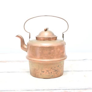 May include: A white ceramic mug with a black handle and the text "But First, Coffee" in a bold, black font. The mug is set against a neutral background, highlighting its simple design.