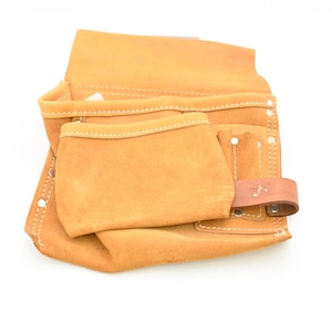 May include: A tan leather tool belt with multiple pockets and a belt loop. The tool belt is made of a durable material and is designed to hold various tools. The stitching is visible.