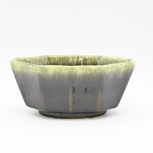 May include: A dark green and light green glazed ceramic bowl with an octagonal shape.