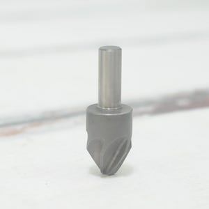 May include: A silver-colored deburring tool with a pointed tip and a cylindrical shaft.
