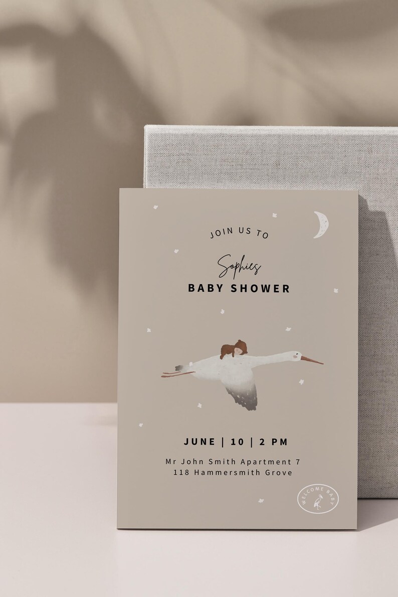 May include: A baby shower invitation with a beige background. The invitation features the text "Join us to Sophies BABY SHOWER" and the date "June 10 | 2 PM". A stork carrying a baby is illustrated on the invitation.