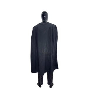May include: A black cape worn over dark trousers on a mannequin. The cape is long, solid black, and drapes over the shoulders and back. The mannequin has a smooth, featureless black head and stands upright, displaying the full length of the garment.