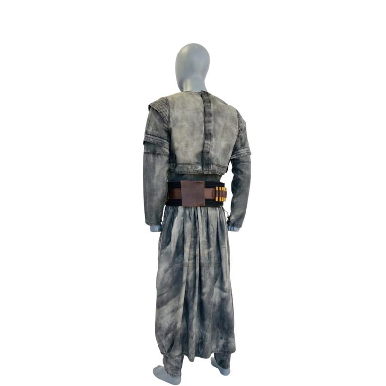 May include: A gray costume with a jacket, long skirt, and belt. The jacket has shoulder pads and long sleeves. The skirt is long and flowing. The belt is brown with gold-colored details. The costume is displayed on a mannequin.