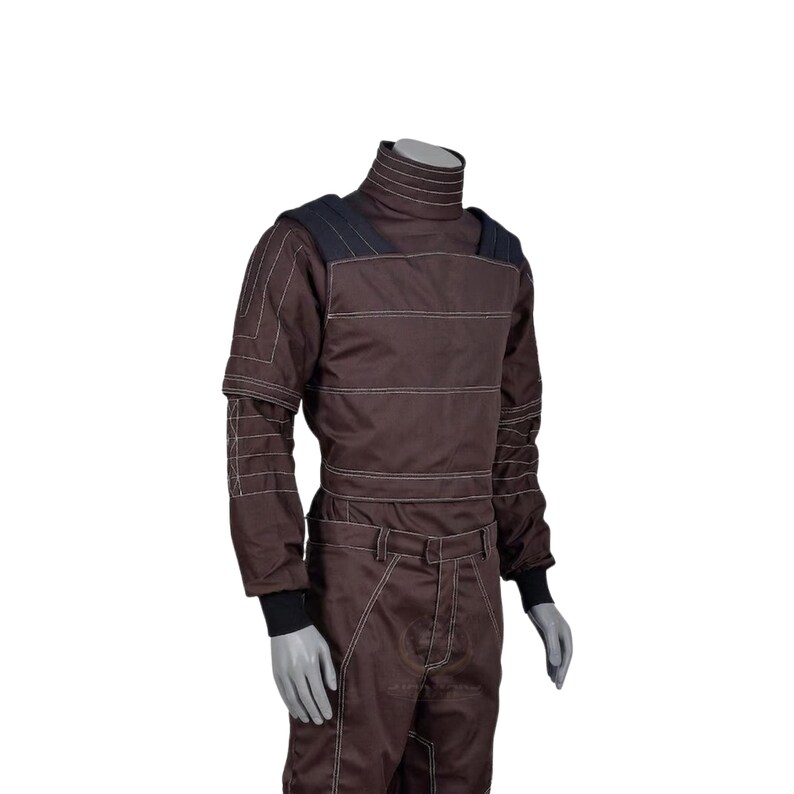 May include: Brown racing suit with white stitching and a high collar. The suit features a dark blue shoulder detail and black cuffs. The suit is designed for protection and speed, with a streamlined silhouette.
