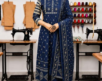May include: A navy blue three-piece outfit consisting of a long-sleeved kurta with a gold geometric print, matching trousers, and a coordinating dupatta. The garment features a round neckline and a repeating pattern of circles and diamonds.