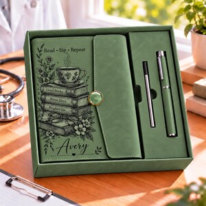May include: A sage green gift set containing a notebook and a matching pen. The notebook cover features a graphic of a teacup on a stack of books with the text Read, Sip, Repeat, Good Books, Better Days, Brighter Me, and the name Avery.