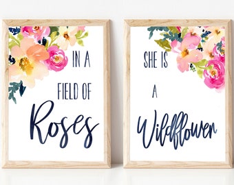 May include: Two framed prints with watercolor floral designs. The left print says "In a field of roses" and the right print says "She is a wildflower".