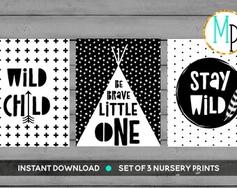 May include: Set of three black and white nursery prints with a geometric pattern background. The prints feature the text "Wild Child", "Be Brave Little One", and "Stay Wild".