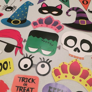 May include: A set of 15 Halloween-themed photo booth props, including a witch's hat, a skull, a pirate's eye patch, a crown, a Frankenstein mask, and a 'BOO!' sign. The props are printed on cardstock and are perfect for adding a festive touch to your Halloween party.