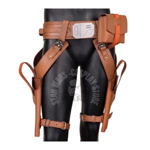 May include: Brown leather cosplay belt and holster set. The belt features a silver buckle and a small pouch with orange accents. Holsters are attached to the legs with straps. The set is designed for cosplay.