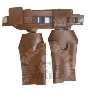 May include: A brown leather belt and leg armour set. The belt has two pouches, a rectangular buckle, and a central panel. The leg armour features a curved design. This set is likely for cosplay or costume use.