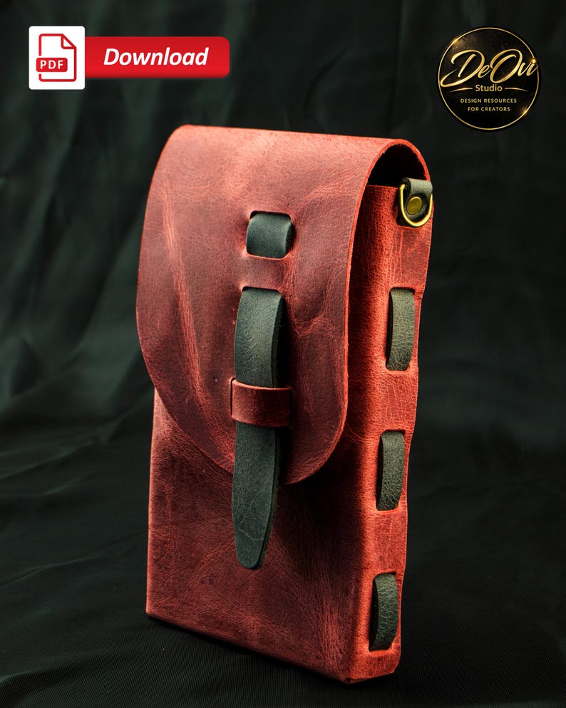 May include: A vertical rectangular pouch crafted from distressed red leather, featuring a fold-over flap secured by a dark green leather strap. The sides are laced with dark green leather strips and include a brass-toned metal ring attachment.