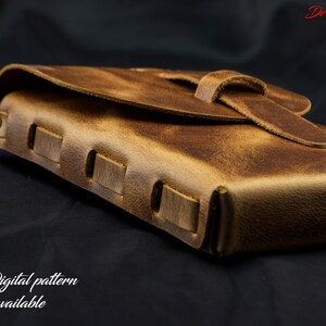 May include: A brown leather journal with a distressed finish, featuring a wrap-around strap closure and visible side stitching. The text DeOvi is in the top right corner, and the text Digital pattern available is in the bottom left corner.