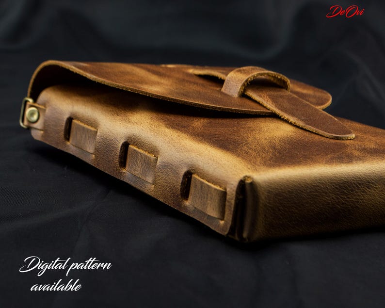 May include: A brown leather journal with a distressed finish, featuring a wrap-around strap closure and visible side stitching. The text DeOvi is in the top right corner, and the text Digital pattern available is in the bottom left corner.
