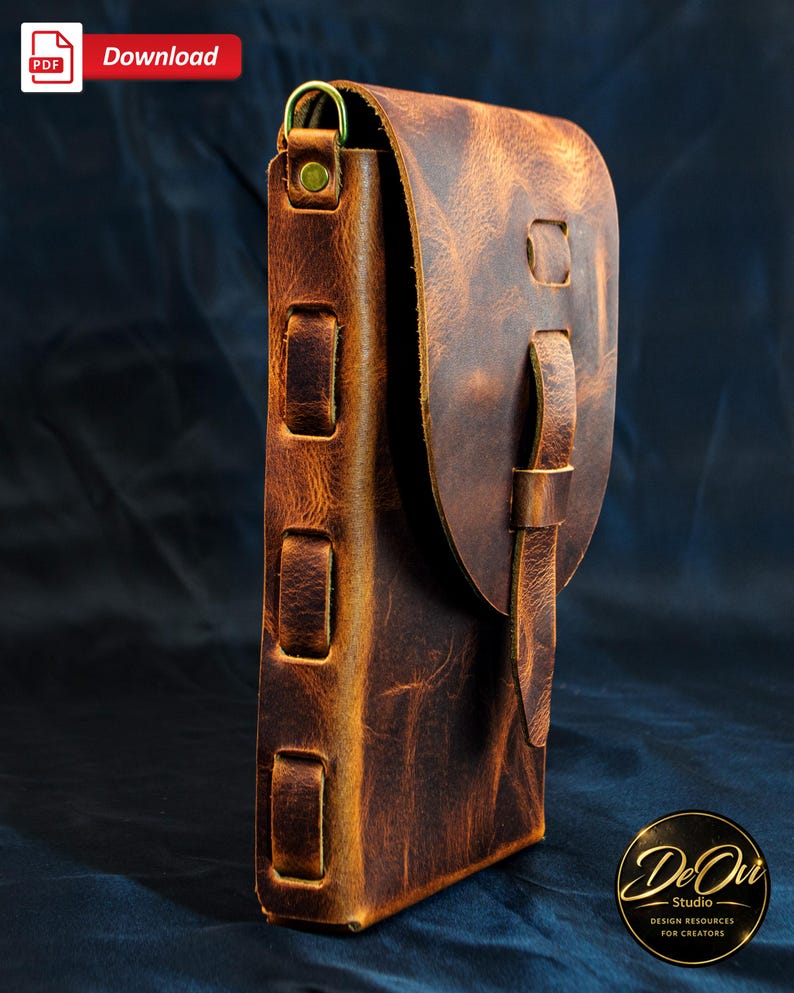 May include: A brown leather pouch with a textured surface, featuring a flap closure secured by a vertical leather strap. The side of the pouch displays three rectangular leather loops and a brass D-ring attachment at the top corner.