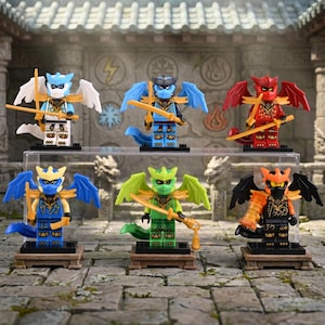 May include: Six colorful Lego figures of dragon-like characters with wings, swords, and masks. The figures are in shades of blue, red, green, and orange, each with unique armor and accessories. They stand on small wooden platforms.
