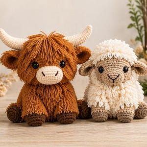 May include: Two handmade crochet toys: a brown Highland cow with cream horns and a cream-coloured sheep. The cow has shaggy fur and a light-coloured snout. The sheep has fluffy wool and a tan face and legs. Both have black eyes.