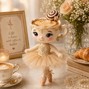 May include: A handcrafted crochet doll in the shape of a teacup ballerina, with a coffee-filled cup for a head. The doll wears a gold tutu and ballet shoes. A framed print reads "Life is better with coffee & ballet."